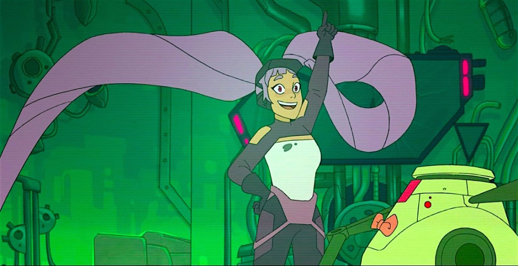 Entrapta, seen through a tracker pad screen, is making a delighted proclamation.  She is smiling, her left hand pointing upward and her right hand on her hip. A small Robot with an orange bow tie is on her left side, watching her.